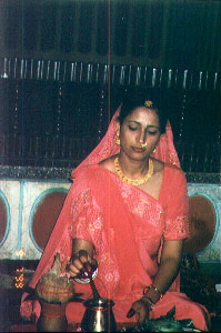 Sunita in the saree from the groom's......offering  chrnamrit