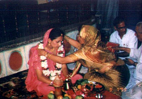 Sasuji offers a garland