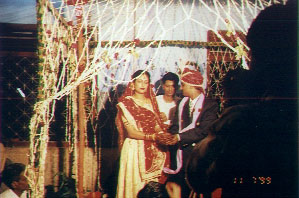 Naresh giving 'kheel' (puffed rice)